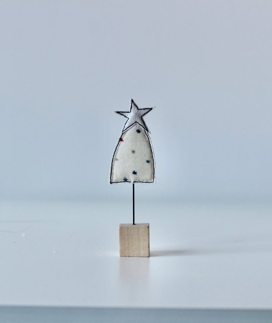 A Christmas Tree with Wire Stem and Wooden Block Stand