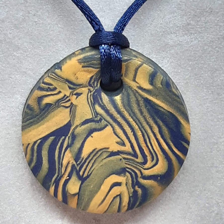 Mustard and navy polymer clay round pendant