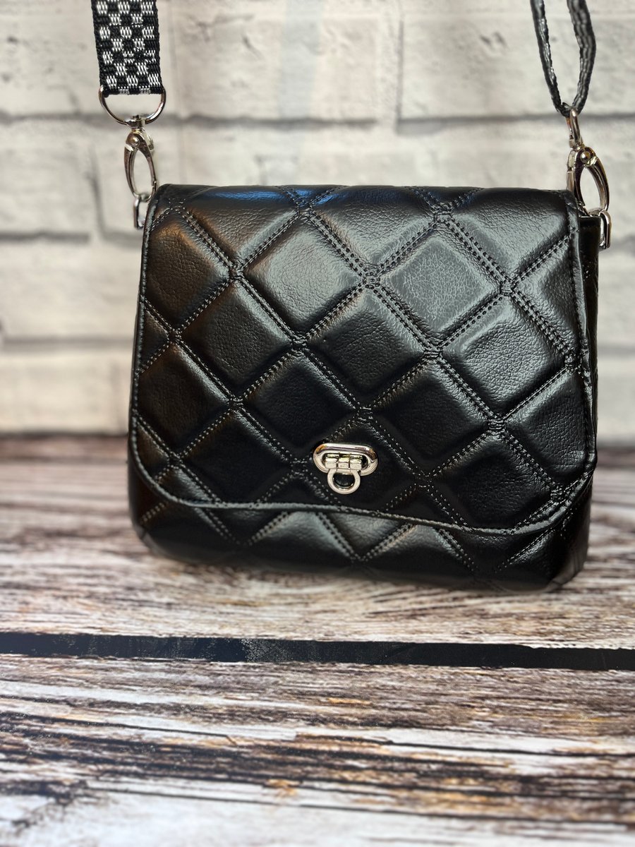 Black quilted crossbody bag with webbing adjustable strap