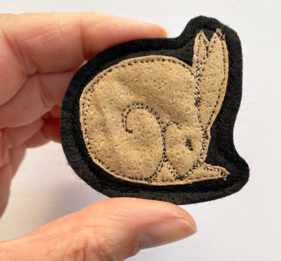 Upcycled sleeping hare brooch pin or badge. 