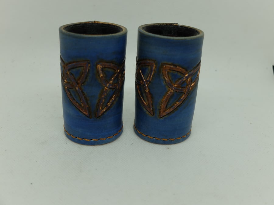 blue and copper effect leather dice cups, pair.Celtic knot design