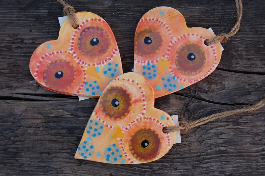 Three ceramic owl hearts