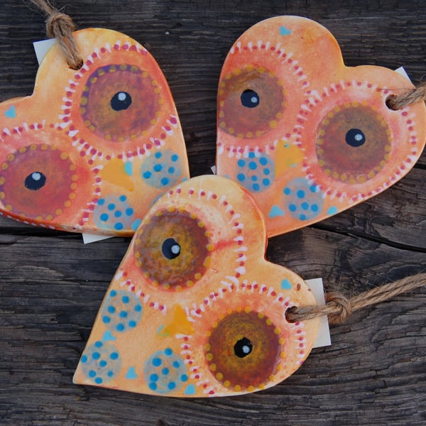 Three ceramic owl hearts