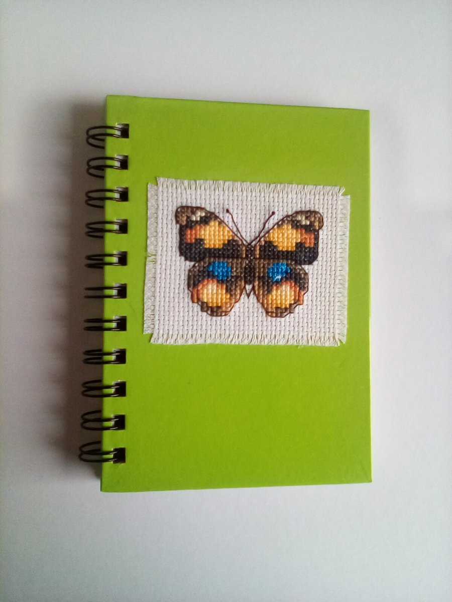 Hand stitched cross stitch butterfly notebook.