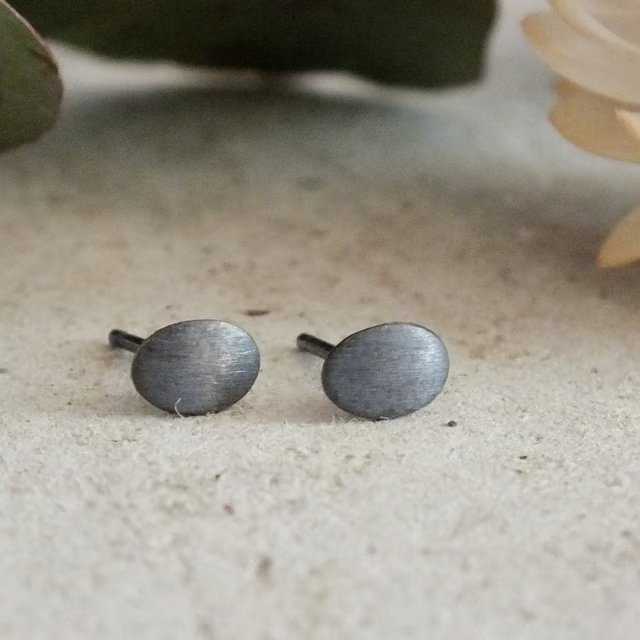 Brushed dark stud earrings; tactile everyday silver studs