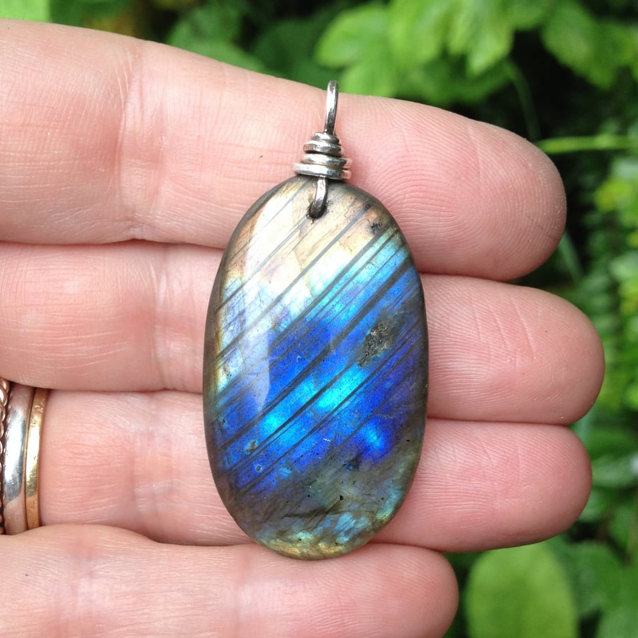 Large labradorite stone pendant with a sterling silver bale