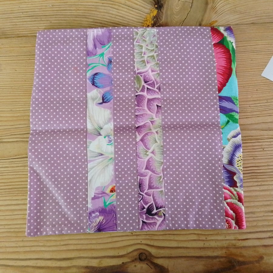 Cushion cover made in a purple polka dot theme with envelope closure.
