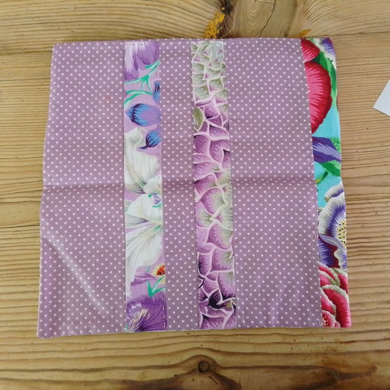 Cushion cover made in a purple polka dot theme with envelope closure.