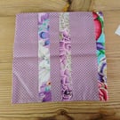 Cushion cover made in a purple polka dot theme with envelope closure.
