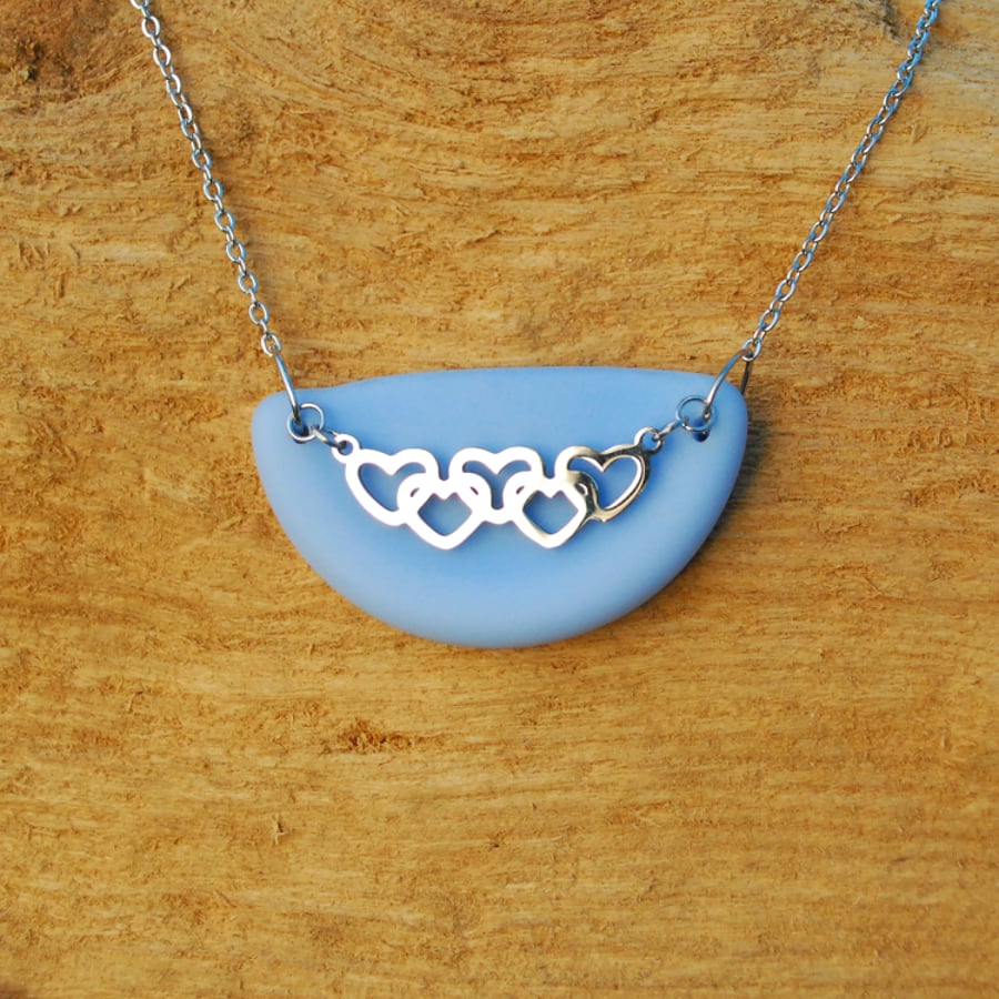 Blue beach glass pendant with multiple hearts