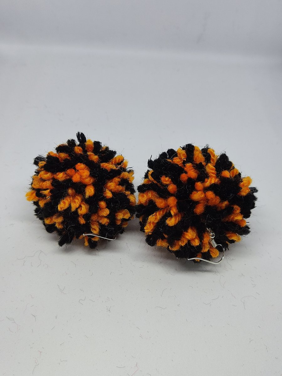 Orange and black pom pom earrings 