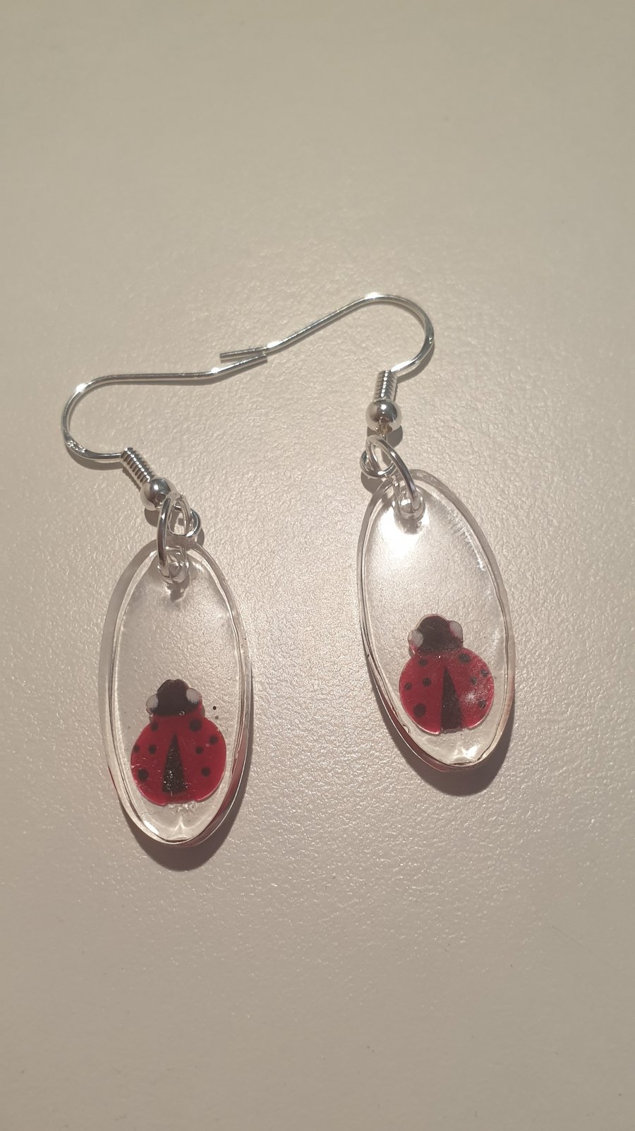 Oval ladybird resin earrings