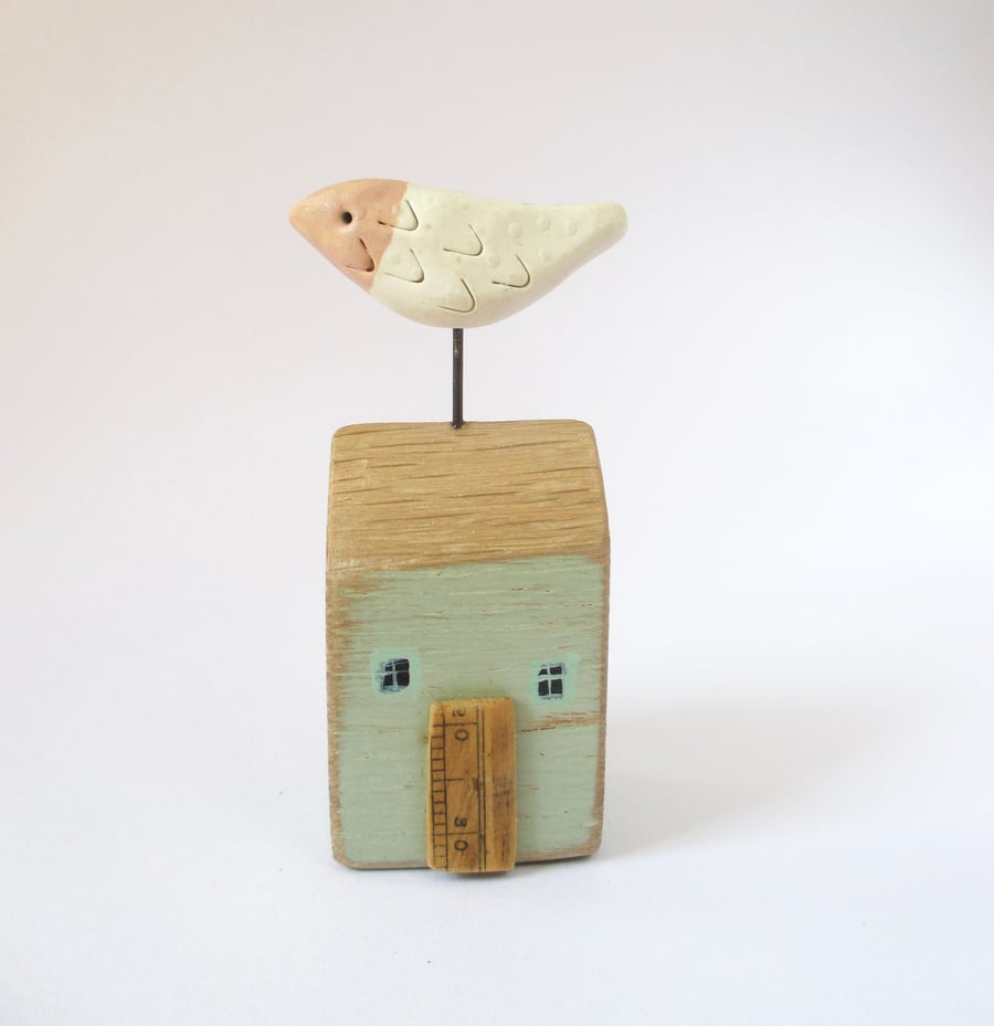Little wooden house with a clay bird