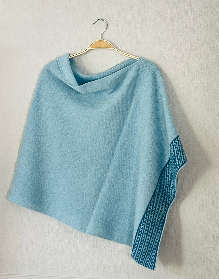 Poncho soft merino lambswool light blue with zigzag petrol blue border