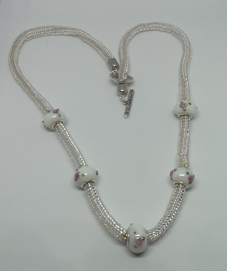 Slinky silver lined bead and Rose Bead necklace.