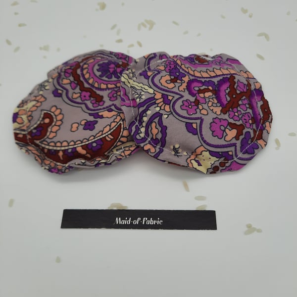 Hand warmers rice filled in purple patterned fabric. 