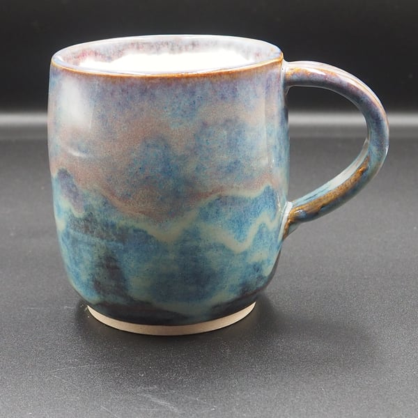 Large stoneware pottery mug fin multi-coloured blue layered and white glaze.
