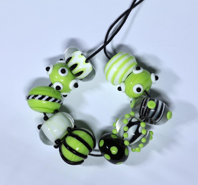 Handmade green, black and white lamp work glass beads