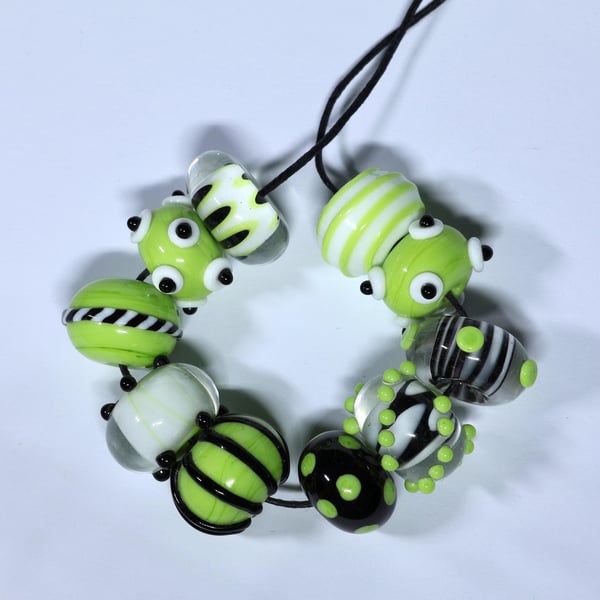 Handmade green, black and white lamp work glass beads