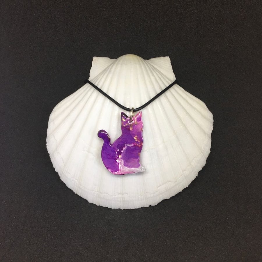 Purple cat pendant resin and ink with black cord necklace.