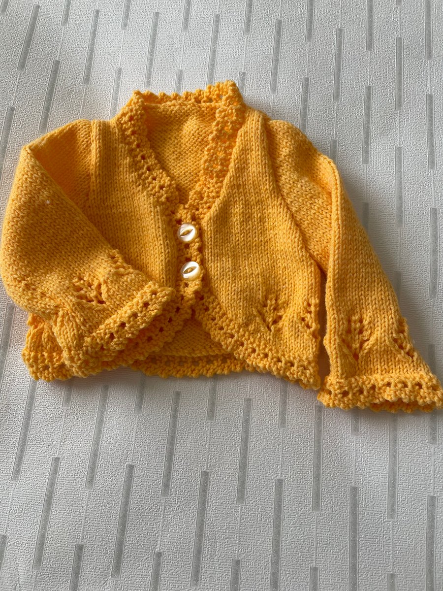 Hand knitted bright yellow long sleeved baby’s bolero 