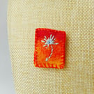 Needle felted and hand embroidered brooch in orange
