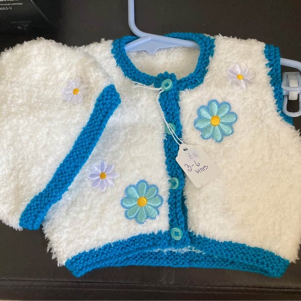 Faux fur waistcoat and hat in white and teal with flower decals