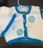 Faux fur waistcoat and hat in white and teal with flower decals