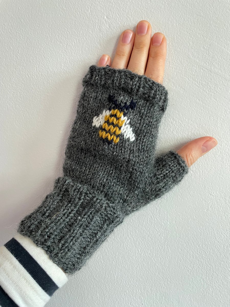 Hand knit dark grey wool fingerless gloves with embroidered bumble bee pattern