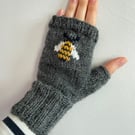 Hand knit dark grey wool fingerless gloves with embroidered bumble bee pattern