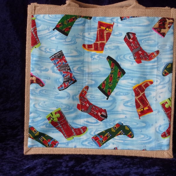 Medium Jute Bag with Boots on a Blue background