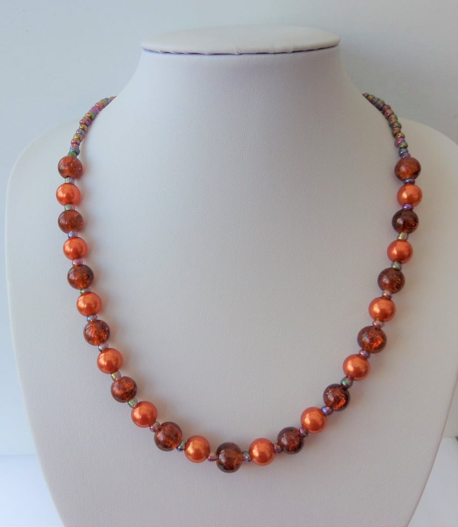 Burnt orange and purple glass and acrylic beaded necklace.