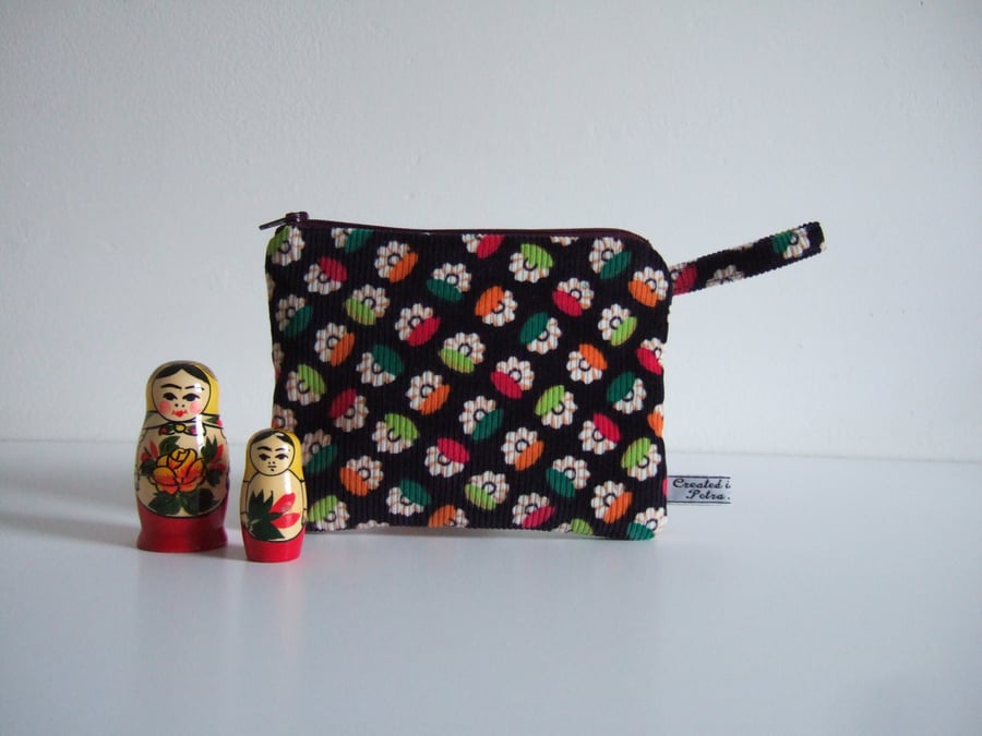A purse for make up, cosmetics, or coins made in vintage corduroy fabric