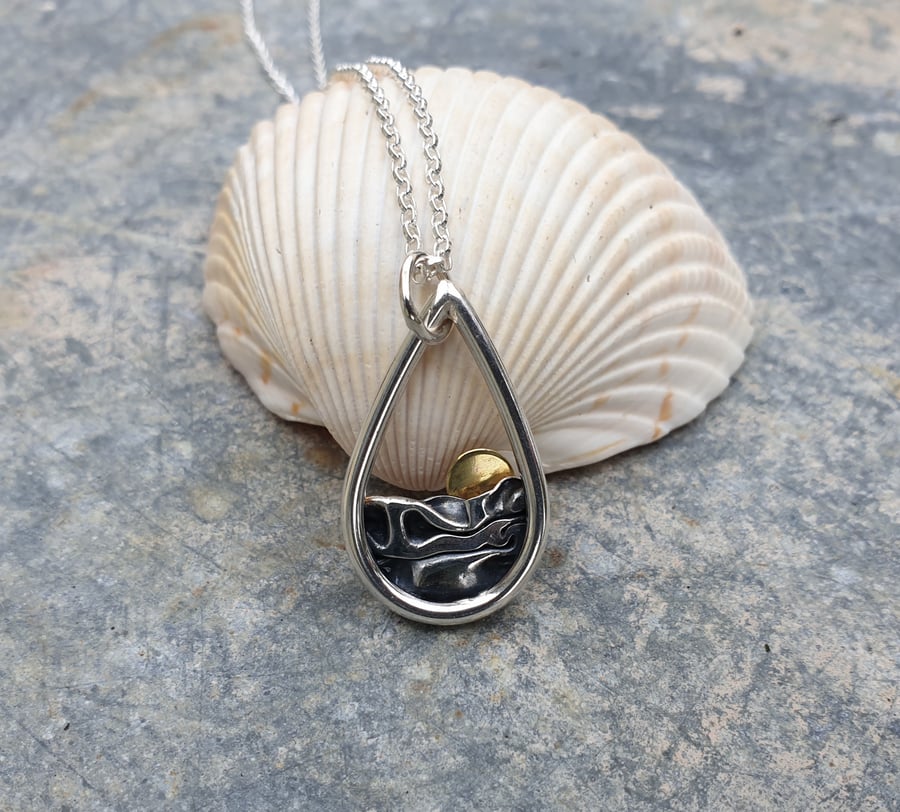 Silver sun rising over sea pendant