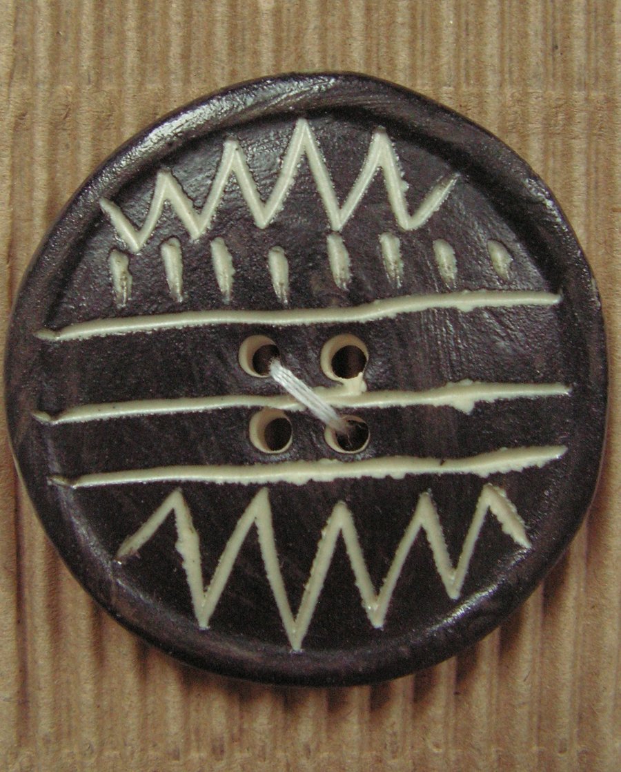 Two ceramic black and white zig zag circle buttons