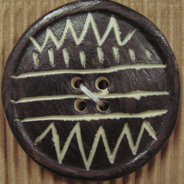 Two ceramic black and white zig zag circle buttons