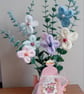 Hand Knitted Flowers on artificial stems displayed in a lovely card teapot