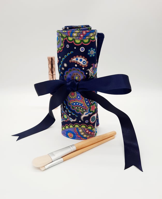 Navy blue make up wrap with colourful pattern. 