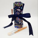 Navy blue make up wrap with colourful pattern. 