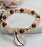 Goldstone and aventurine silver leaf charm stretch bracelet