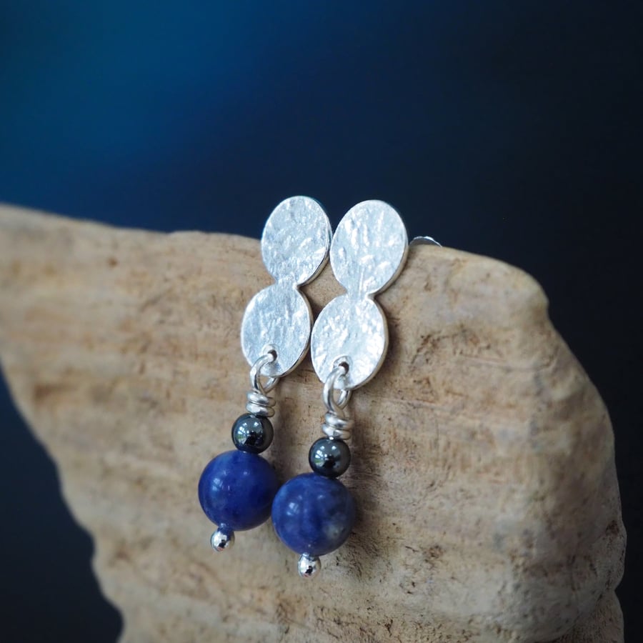 A pair of silver double disc stud earrings. Hematite and sodalite bead drops