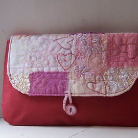 Soft fabric clutch bag with hand and machine embroidery in pink