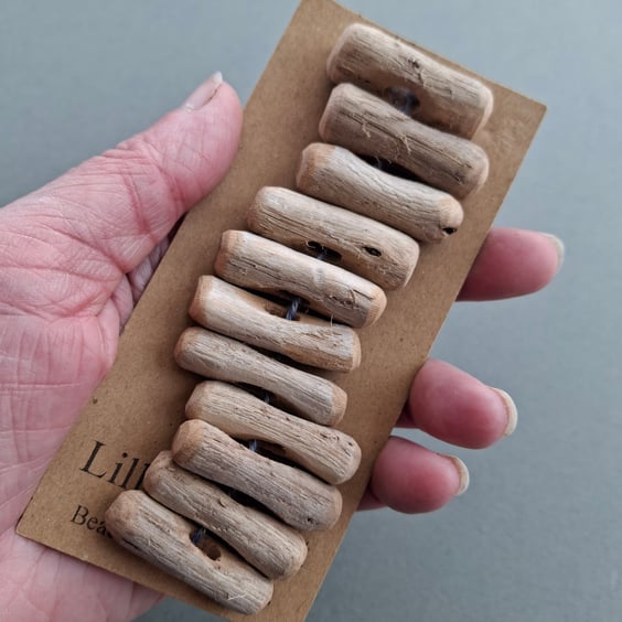 Set of eleven driftwood toggle buttons with single hole