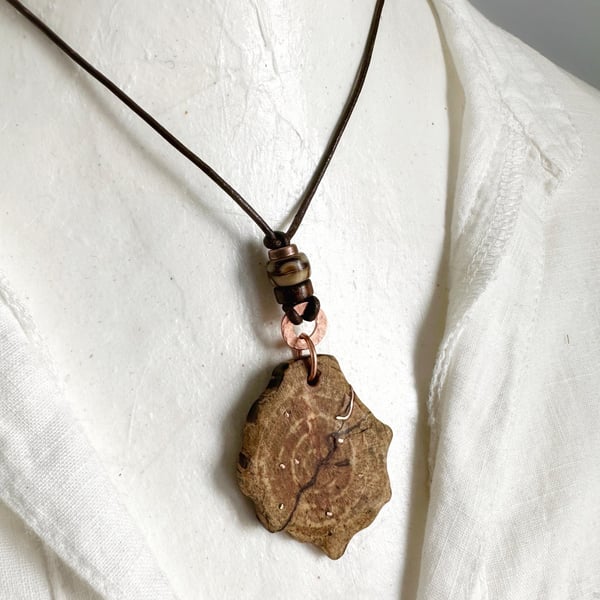 Carved Cherry Wood Pendant Inlaid With Copper On A Leather Cord