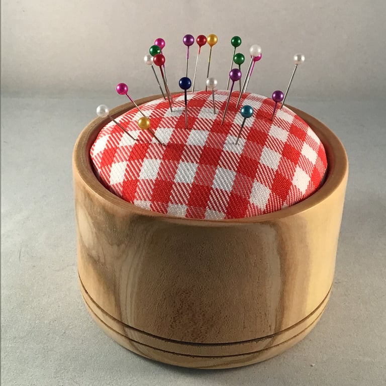 Natural wood pin cushion.