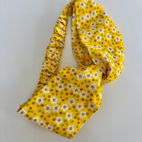 Cotton headband, twist knot style hairband in a yellow and white floral print.