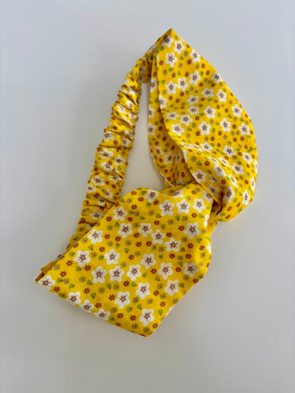 Cotton headband, twist knot style hairband in a yellow and white floral print.