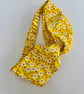 Cotton headband, twist knot style hairband in a yellow and white floral print.