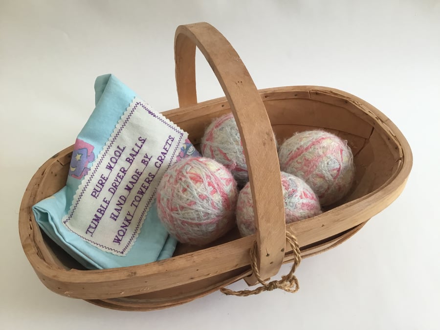 Four wool tumble dryer balls - pastel colours. Energy saving and plastic free.