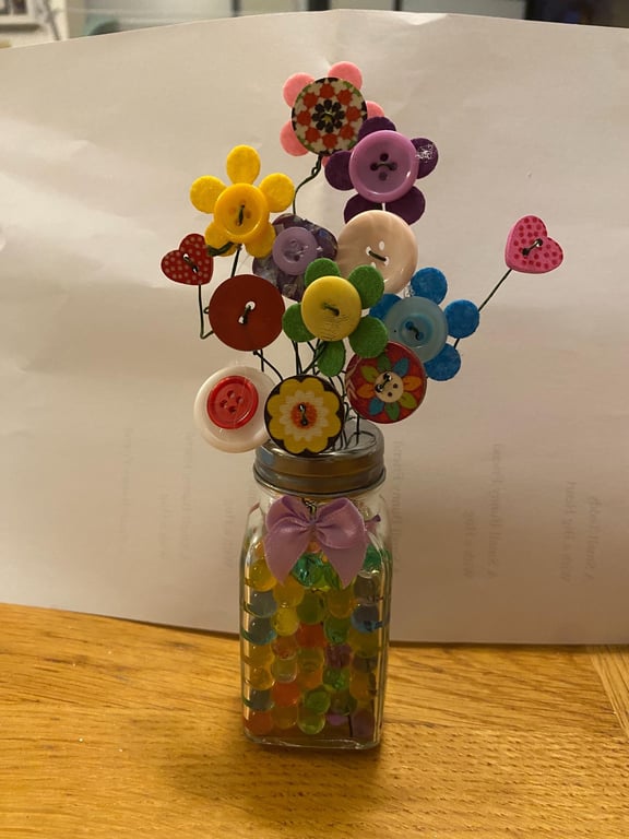 Button flower in a salt shaker vase